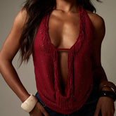 Red fringed top worn by a person on a neutral background